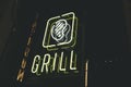 neon sign grill fast food city restaurant yellow color Royalty Free Stock Photo