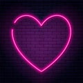 Neon sign in heart shape. Glowing neon heart on brick wall background. Neon signboard, love concept Royalty Free Stock Photo