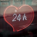 Neon sign in the heart-showcase 24 hours, round the clock Royalty Free Stock Photo