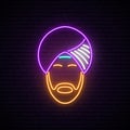 Neon sign of Indian man in national headdress.