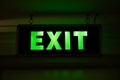 Neon sign with the inscription EXIT. Motion indicator in a dark room or space during evacuation