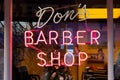 Closeup of Dons Barber Shop Neon window sign from street