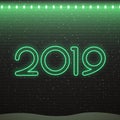 Neon sign of 2019 logo for decoration on the brick wall background. Concept of Merry Christmas and Happy New Year.