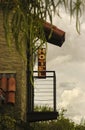 A neon sign for an old hotel is highlighted against brooding storm clouds in the background. Royalty Free Stock Photo