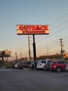 Neon sign, Outback Steakhouse in sunset background, Florida