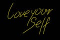 Neon sign phrase Love yourself on black background isolated.