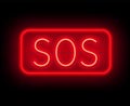 Neon sign SOS. The inscription on a dark background Royalty Free Stock Photo