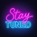 Neon sign stay tuned on brick wall background. Royalty Free Stock Photo