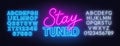 Neon sign stay tuned on brick wall background. Royalty Free Stock Photo