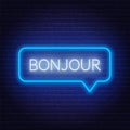 Neon sign of word bonjour in speech bubble frame on dark background. Greetings in French.