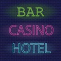 Neon signs hotel casino bar on brick wall background