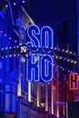 Neon signs for the neighborhood Soho at night London United Kingdom