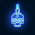 Neon skull with candle on brick wall