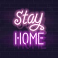 Neon stay home handwritten lettering. Glowing vector motivation typography. Fluorescent letters on dark brick wall