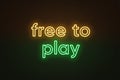 Neon text Free to play, yellow and green color. Business model in video games industry with main content without paying