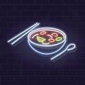 Neon tom yum bowl icon on brick wall background. Asian noodle soup. Vector isolated illustration for restaurant menu or