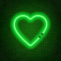 Neon tubes in the shape of a heart isolated on a brick wall background. Sign of love. Royalty Free Stock Photo