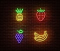 Neon vegetables fruits signs vector isolated on brick wall. Pineapple, strawberry, grape, banana lig