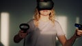 Neon VR gamer girl portrait. Happy woman in virtual reality in the light of the setting sun from the window. Game man in