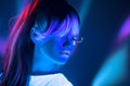 Neon Woman dancing. Fashion model woman in neon light, portrait of beautiful model with fluorescent make-up, Night club Royalty Free Stock Photo