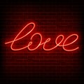 Neon word love. A bright red sign on a brick wall. Element of design for a happy Valentine s day. Vector illustration Royalty Free Stock Photo