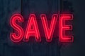 Neon word SAVE on dark shabby wall