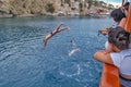 Tourists jump into the water