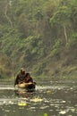 A man and a woman on a dugout boat. Royalty Free Stock Photo