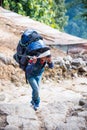 Nepal - 25 December 2016 :: Sherpas carry heavy backpack and walk to mountain