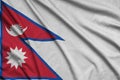 Nepal flag is depicted on a sports cloth fabric with many folds. Sport team banner