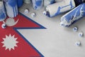 Nepal flag and few used aerosol spray cans for graffiti painting. Street art culture concept