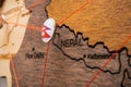 Nepal flag on the pin with red thread showed the paths on the wooden map.