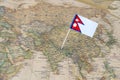 Nepal flag pin on a world map Royalty Free Stock Photo