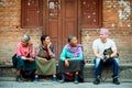 Nepal, Kathmandu, Palace Square - April 26, 2014: European tourist talks with locals on the street of the old city