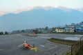 Helicopter stands on the runway at dawn in Himalayas