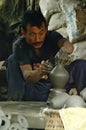 Nepalese artisan makes a clay pot modelled with his hands