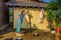 Nepalese girl gets water from a well in Nepal