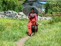 Nepalese girl with umbrella and dog in Tatopani, Nepal Royalty Free Stock Photo