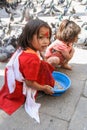 Nepalese girls feeding pigeons