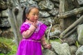 Nepalese little girl in violet dress in Nepal village