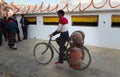 Nepalese man transporting 3 gas cylinders on his bicycle at Bodnath Stupa,