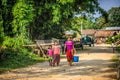 Nepalese mother with two children walk through their village