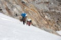 Nepalese Mountain Porters climbing Glacier on steep Ice Wall Royalty Free Stock Photo