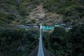 Nepalese mountain village by a suspension bridge over the Marshyangdi river Royalty Free Stock Photo