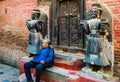 Nepalese old men sitting in front of wall located in Bhaktapur Royalty Free Stock Photo