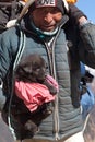 Nepalese porter carrying a havy load and a Tibetan mastiff