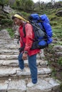 Nepalese porter carrying heavy load. Royalty Free Stock Photo