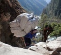 Nepalese porter carrying a heavy load, Nepal Himalayas Royalty Free Stock Photo