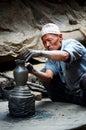 Nepalese potter working in the his pottery workshop