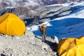 Nepalese Sherpa Porter carrying wicker Basket in Mountain Expedition Camp